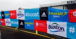 Advertising hoardings showing the Adidas #Boost hashtag and other brand logos